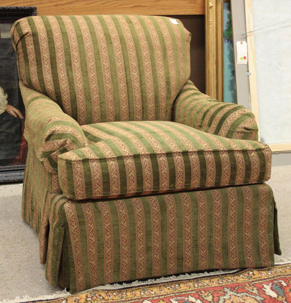 Classic style lounge chair: Classic style lounge chair with a rolled back and scrolled arms, in a striped green velvet and beige/red floral tapestry style upholstery, and skirted with corner pleats