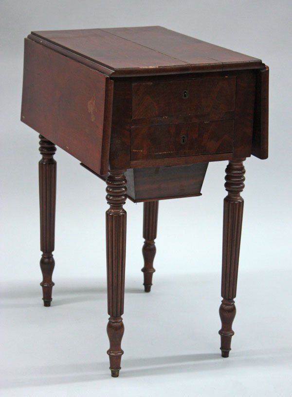 Mahogany drop leaf sewing table: Mahogany drop leaf sewing table, circa 1910, with two drawers above a concealed box on ring turned supports, reeded legs with shaped feet, 28''h x 30''w x 21''d