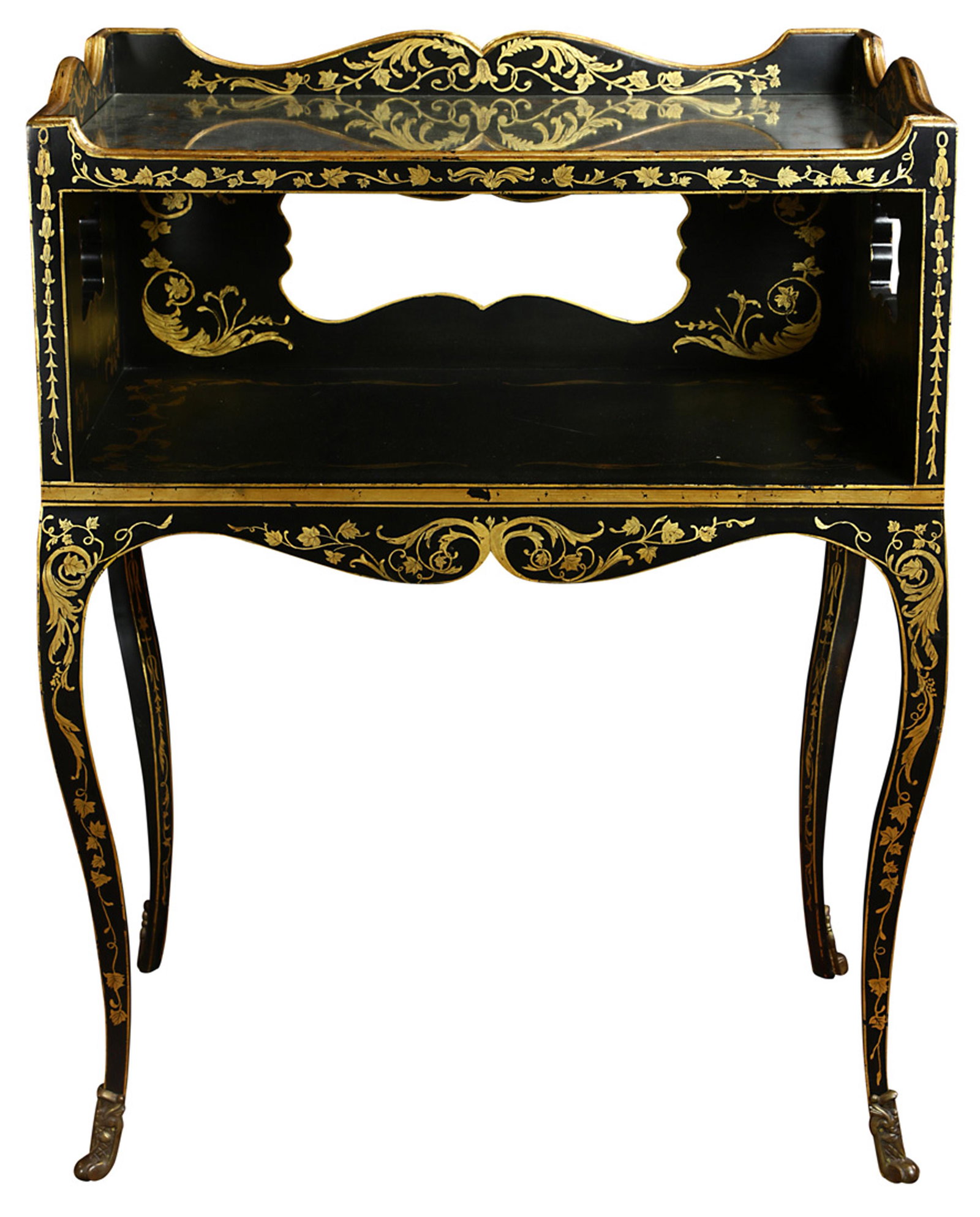 A Napoleon III style ebonized and partial gilt tiered: A Napoleon III style ebonized and partial gilt tiered table, the case with floral detail surrounding the mirror top having conforming floral detail, and rising on cabriole legs terminating on sabots, 