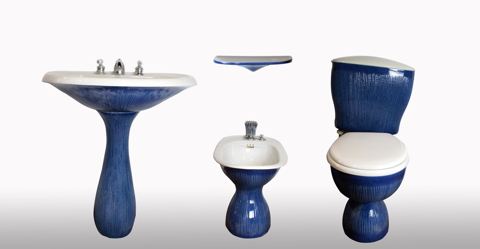 Antonia Campi of Richard Ginori bathroom fixture suite: (lot of 4) An Antonia Campi of Richard Ginori bathroom fixture suite, each having a textured blue body, consisting of a pedestal sink, a wall mount rack, toilet, and bidet, each marked Richard Ginori