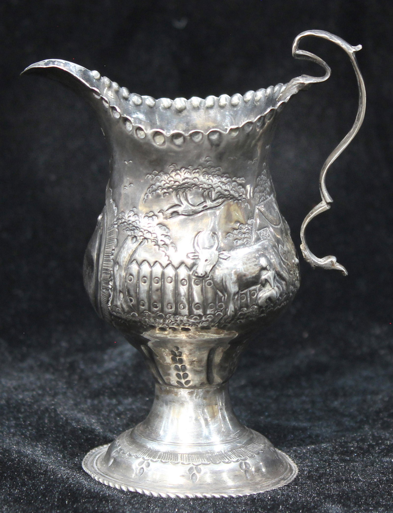 Victorian repousse sterling creamer, Samuel Jacob,: A Victorian repousse sterling creamer, Samuel Jacob, London, circa 1896, the footed baluster form with scene of farmyard in raised relief, 5"h, 2.5 toz