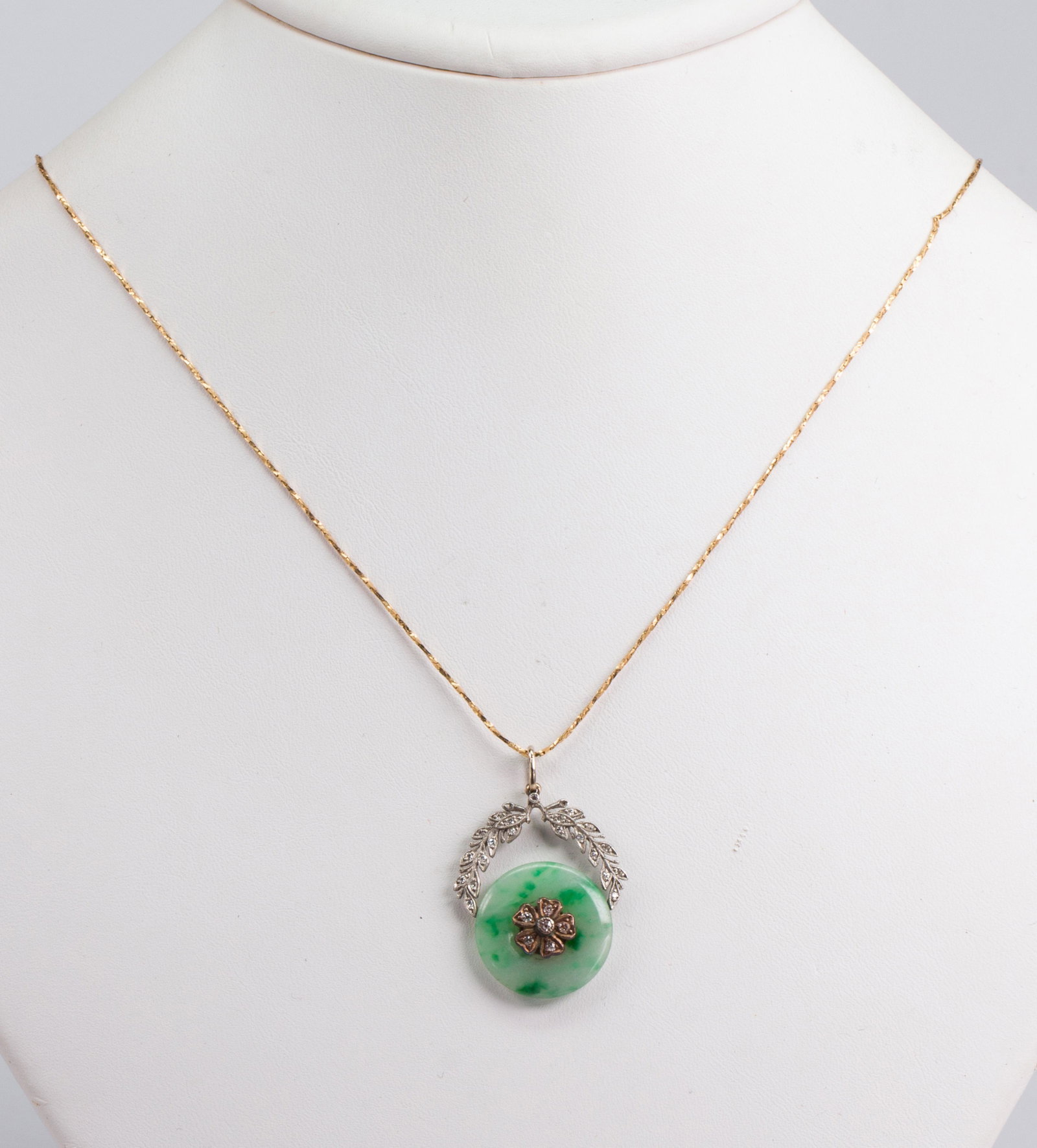 Jadeite, diamond, platinum, gold, silver: Jadeite, diamond, platinum, gold, silver pendant-necklace Including 1) jadeite disc, measuring approximately 18 mm, accented by (27) old-cut diamonds, weighing a total of approximately 0.15 ct., set i