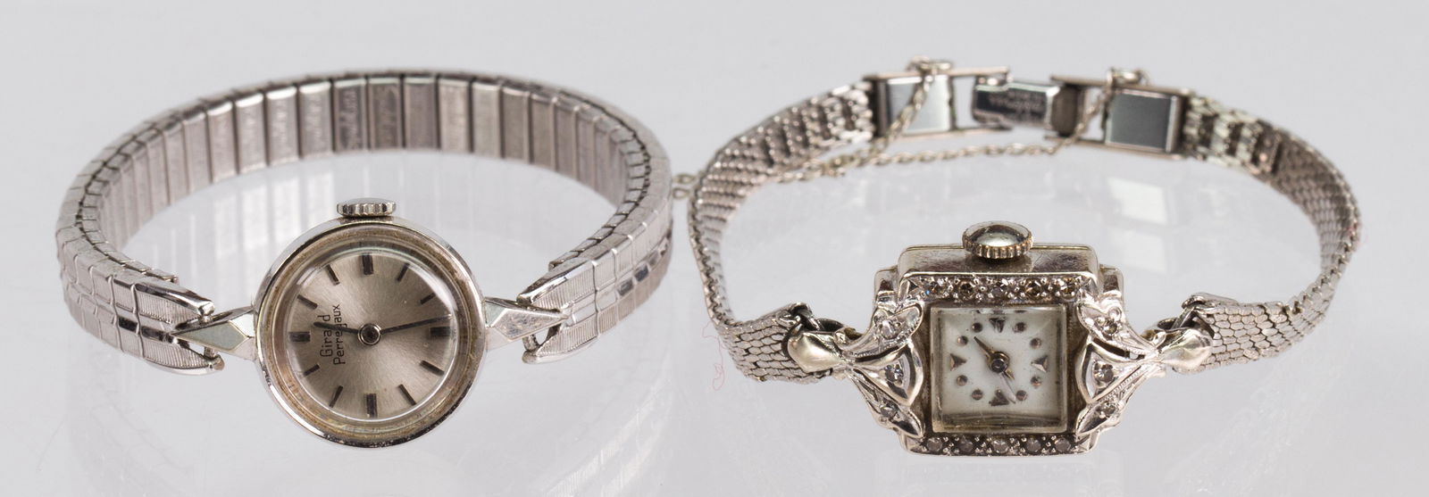 (Lot of 2) Lady's white gold wrist watches: (Lot of 2) Lady's white gold wrist watchesIncluding 1) lady's 17 jewel, Girard Perregaux, round, 18k white gold, metal wristwatch; together with 1) lady's 17 jewels Bucherer, rectangular, diamond, 14k