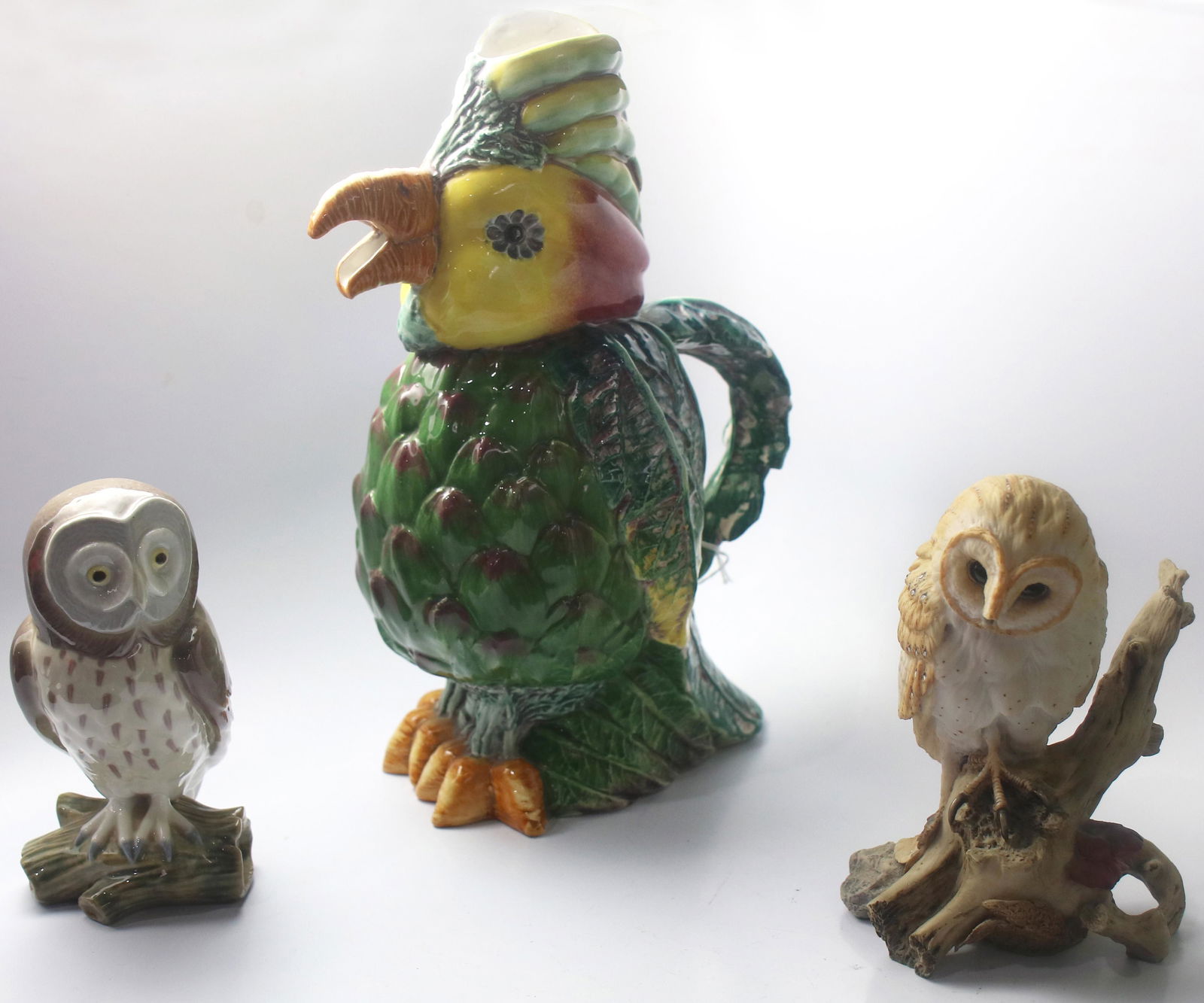 (lot of 3) Figural scuptures of owls: (lot of 3) Figural scuptures of owls, including one Lladro example, together with a parrot form pitcher, 12"h