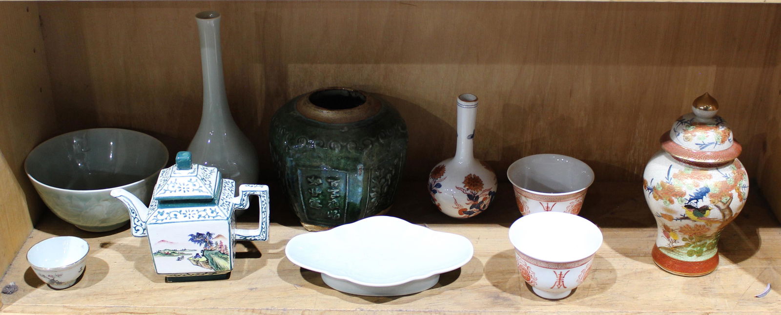 One shelf of Asian ceramics including Chinese teapot (1 of 1)