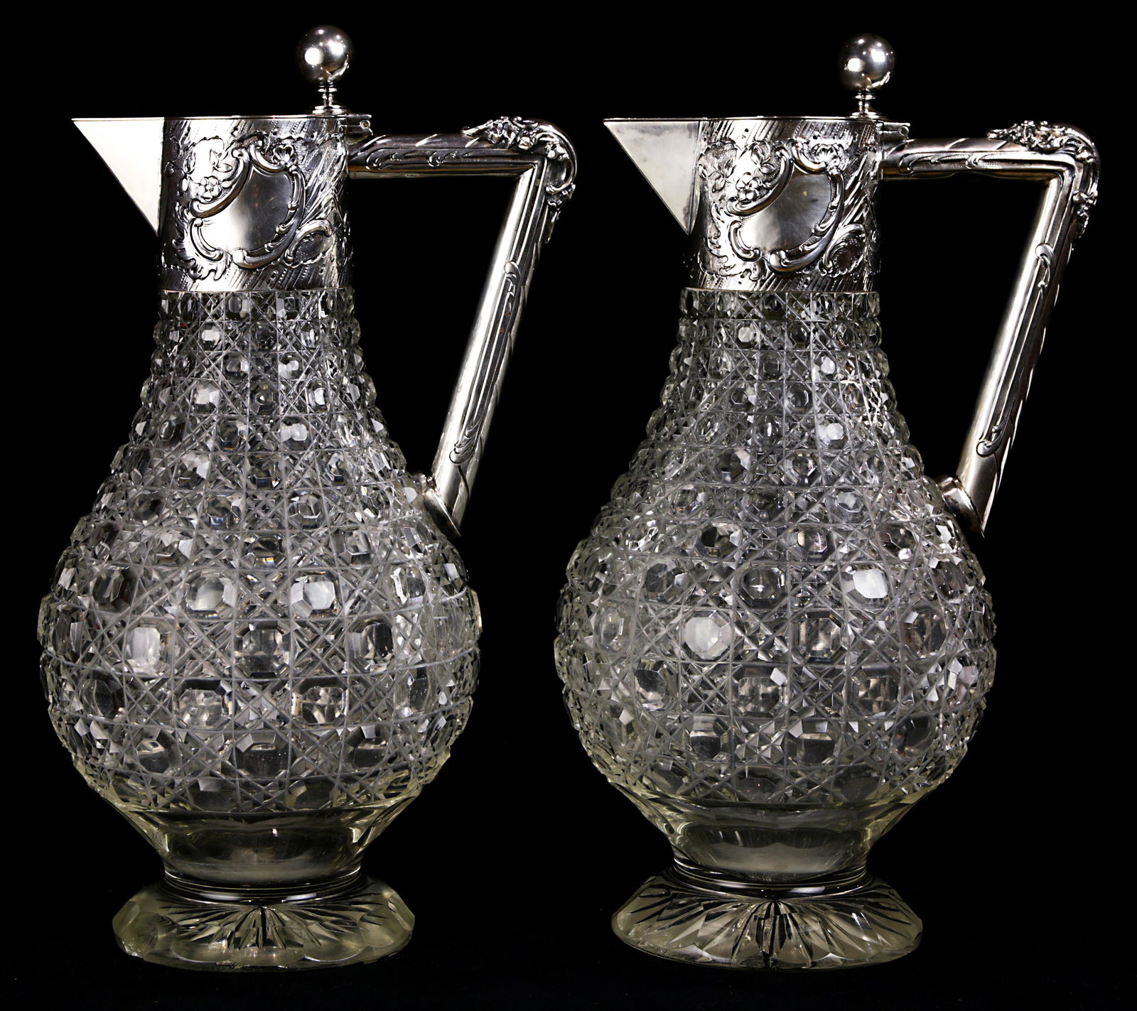 A pair of German .830 silver mounted claret jugs (1 of 2)