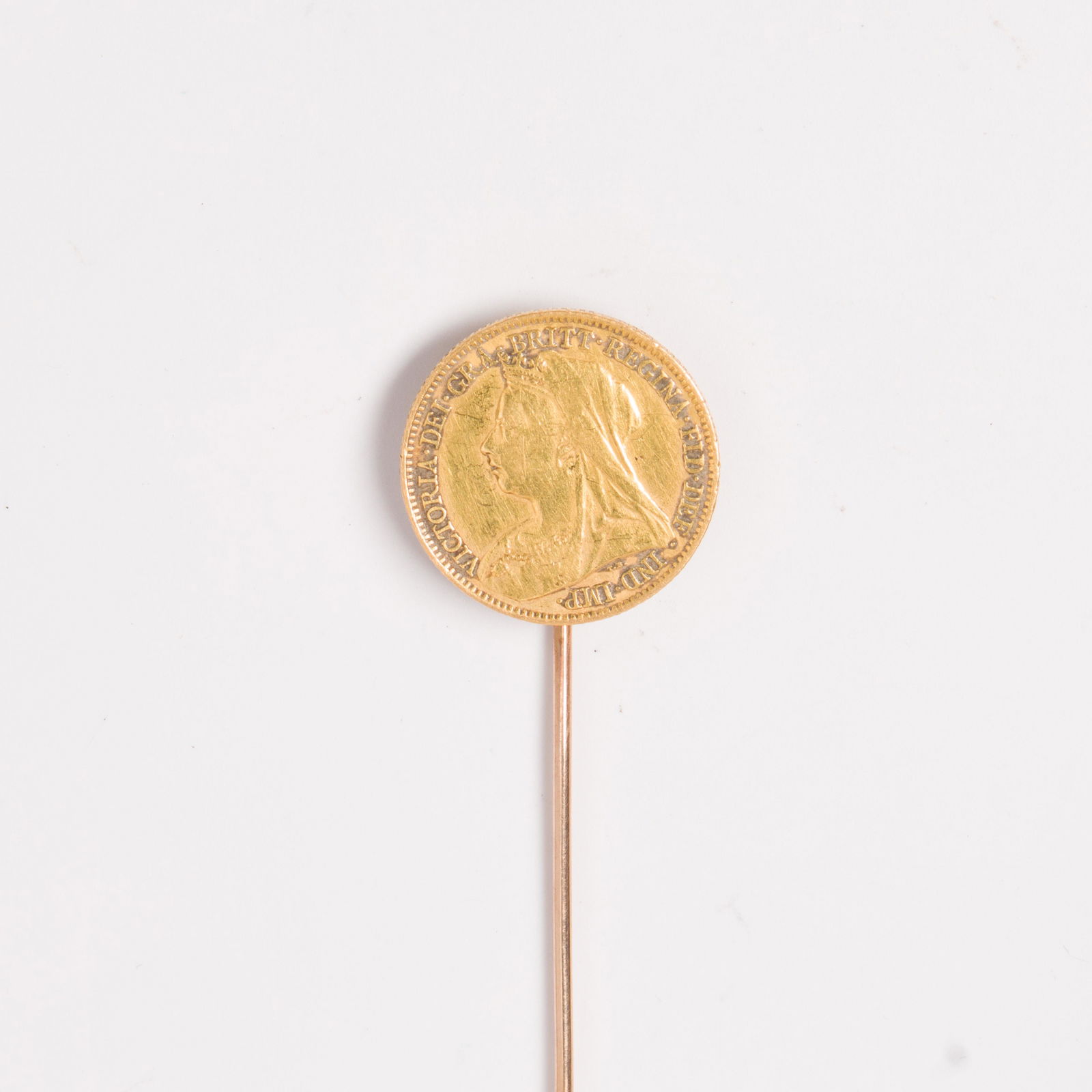 A gold coin and fourteen karat gold stick pin (1 of 2)