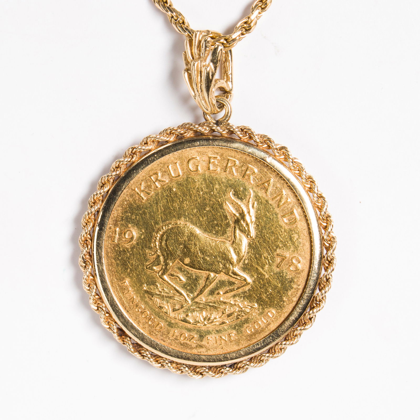 A gold coin and fourteen karat gold pendant necklace (1 of 2)