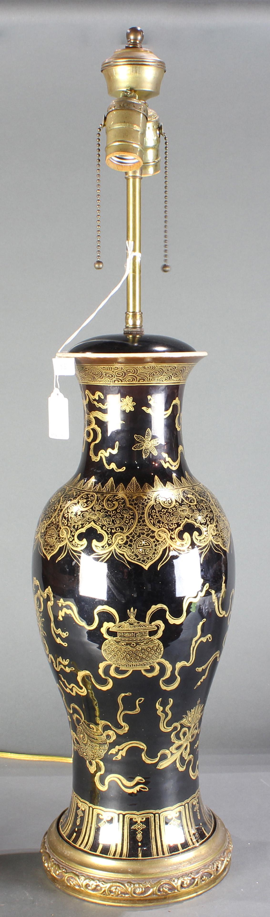 A Gilt-Decorated Black-Glazed 'Bajixiang' Lamp: A Gilt-Decorated Black-Glazed 'Bajixiang' Lamp, the lamp base of elongated baluster form rising from a spreading foot to a short waisted neck, painted in gilt with the bajixiang, 'Eight Buddhist Emble