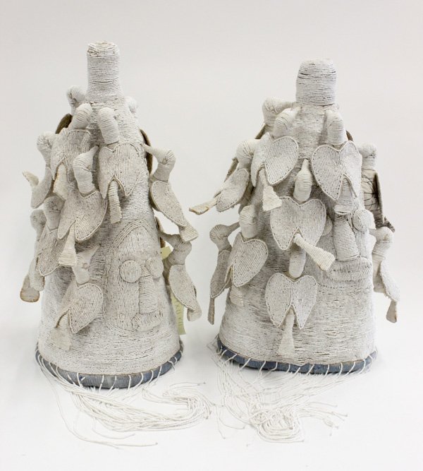 Beaded ceremonial crown Yoruba Nigeria: (lot of 2) Beaded ceremonial crowns, Yoruba tribe, Nigeria, conically shaped in a subtle white on white decorated throughout and surmounted with birds, long white beaded fringe, the larger 19''h x 11'
