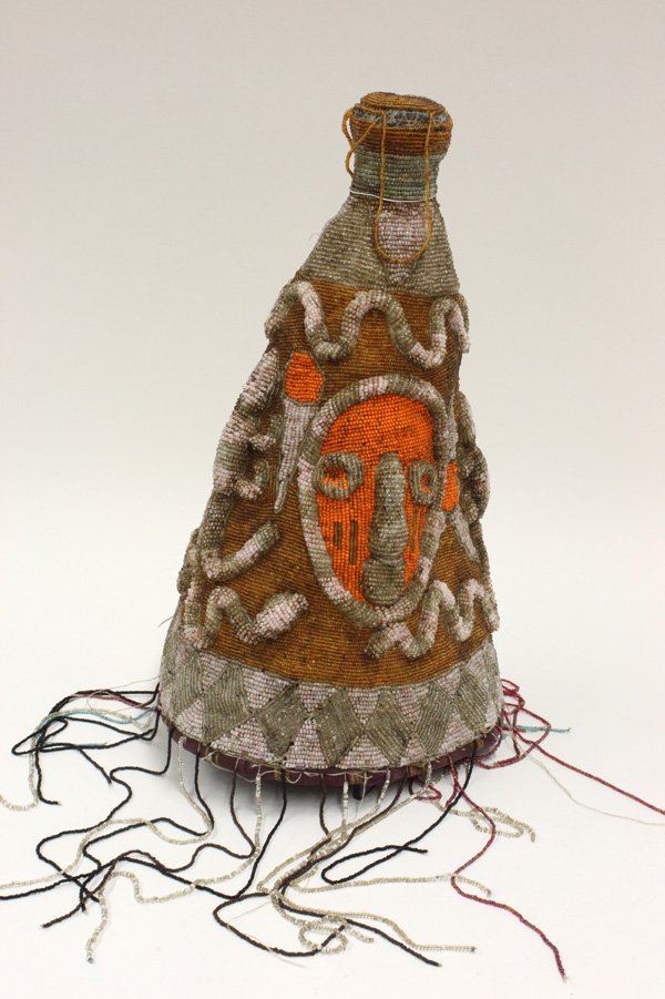 Beaded ceremonial crown Yoruba Nigeria: Beaded ceremonial crown, Yoruba tribe, Nigeria, conically shaped with raised designs, orange masks and pink and brown lizards over a brown ground, with long, colorfully beaded fringe, 18''h x 9''d (la