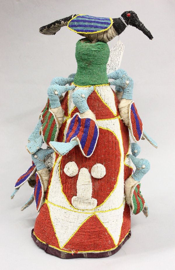 Beaded ceremonial crown Yoruba Nigeria: Beaded ceremonial crown, Yoruba tribe, Nigeria, conically shaped with birds over a red and white mask designed background, 19''h x 12''w x 11''d