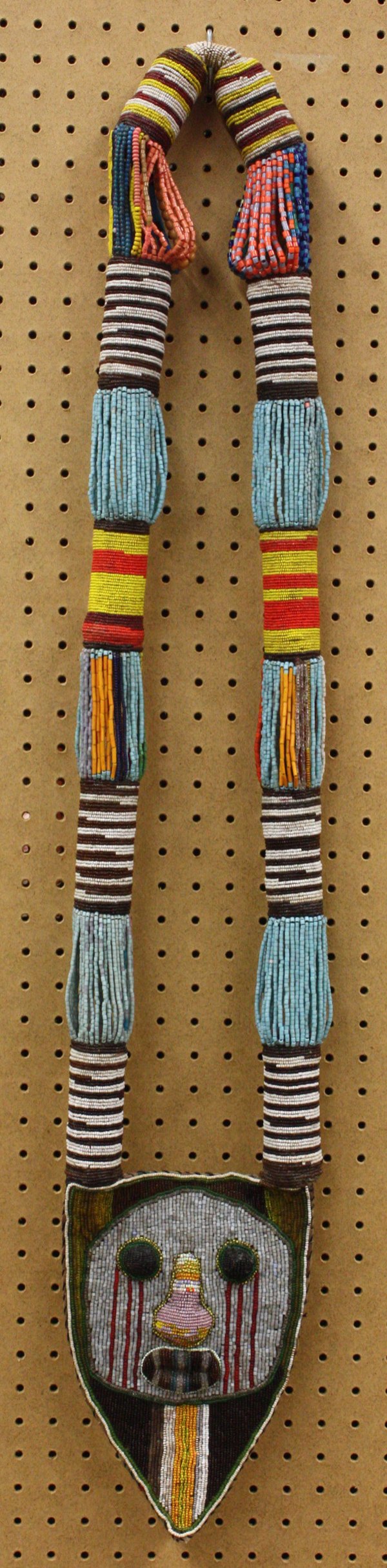 Beaded emblem necklace, Yoruba Nigeria: Beaded ceremonial emblem, Yoruba tribe, Nigeria, made for use, with signs of wear, 43''h x 8''w x 2''d