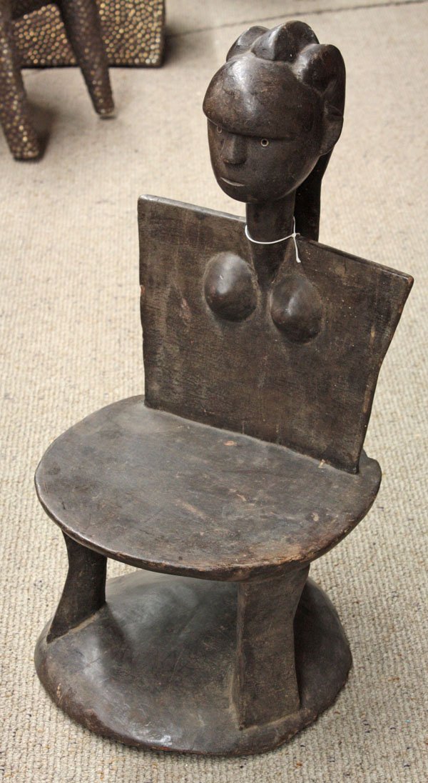 Carved wood chair Kwere style Tanzania: (lot of 3) Carved wood chairs, in the style of the Kwere tribe, Tanzania, with figural accents and detailed coiffures, the largest 28''h x 14''w x 12''d