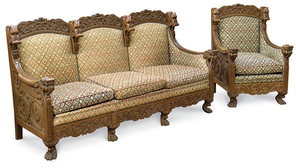 Two piece parlour suite, Nordic design: Two piece parlour suite, ornately carved mahogany in Nordic design, including sofa and matching chair, both adorned with figural dragon heads, the crests and arm ends embellished with writhing dragons