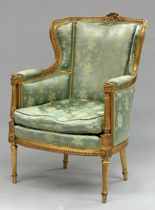 Louis XVI style gilt wood bergere: Louis XVI style carved gilt wood bergere in aquamarine silk upholstery patterned by ivory floral bouquets, contained in a molded frame with floral cresting and beading on fluted legs, 38.5'' x 28.5' x