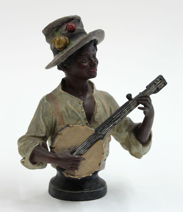 Ceramic hand painted bust Blackamoor: (lot of 2) Ceramic hand painted bust modelled after a female Blackamoor figure, 13''h, and a ceramic figure playing the banjo, 8.5''h