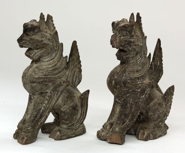 Southeast Asian Wood Lion Figurines: (lot of 2) Southeast Asian wood figures of temple lions, each seated with flame-like appendages issuing from the legs and mouth open in mid-roar (wear), 6.5''h