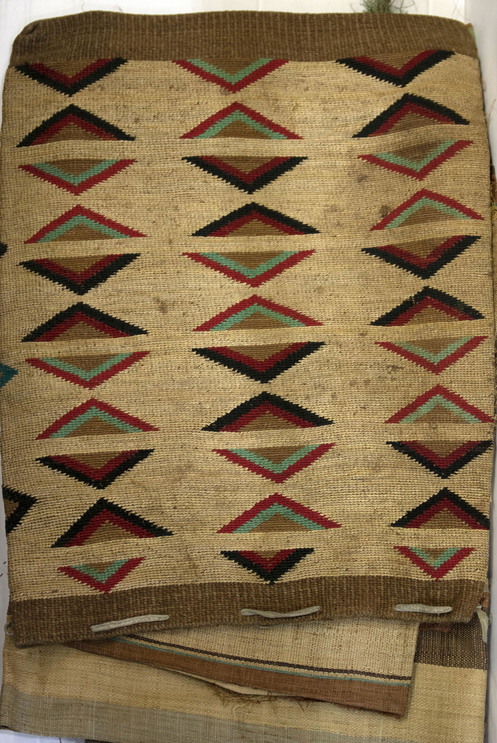 (lot of 6) Native American Bag group: (lot of 6) Native American woven bag decorated with diamonds; together with (5) Ethnic woven striped raffia textiles, possibly African, including table runners and a tablecloth, each with a sticker fr