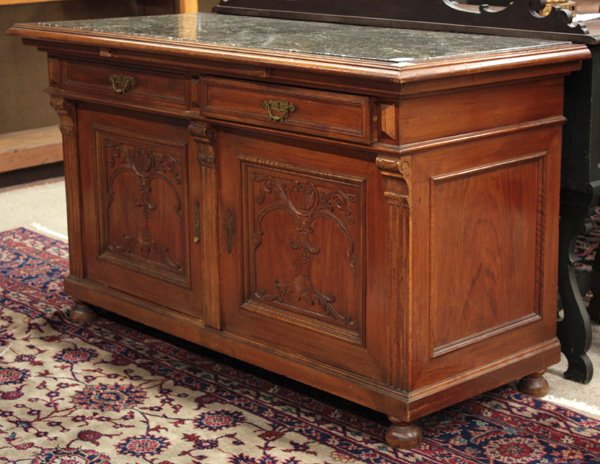 Carved Napoleon III walnut sideboard: Carved Continental circa 1890 walnut sideboard with marble inset top with molded edge, above double silver drawers over double cabinet doors with floral and shell carved relief, 35''h x 62''w x 26.5''