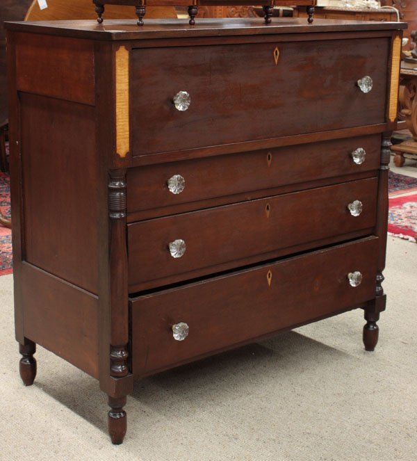 Ohio chest of drawers, circa 1825: Ohio chest of drawers, circa 1825, walnut with tiger maple inlay and escutcheons, turned split pilasters rising on turned legs, retaining glass pulls, 40''h x 41''w x 19.5''d (key in office)