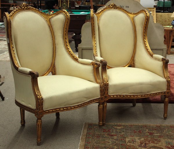 giltwood winged bergeres: Pair of giltwood winged bergeres with rose carved crest rails, rising on fluted legs, 47''h x 29''w x 28''d