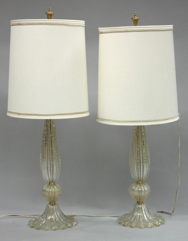 Murano art glass table lamps: Pair of vintage Murano art glass table lamps of cased clear glass with bubble and gold dust inclusions having linen shades, 41''h