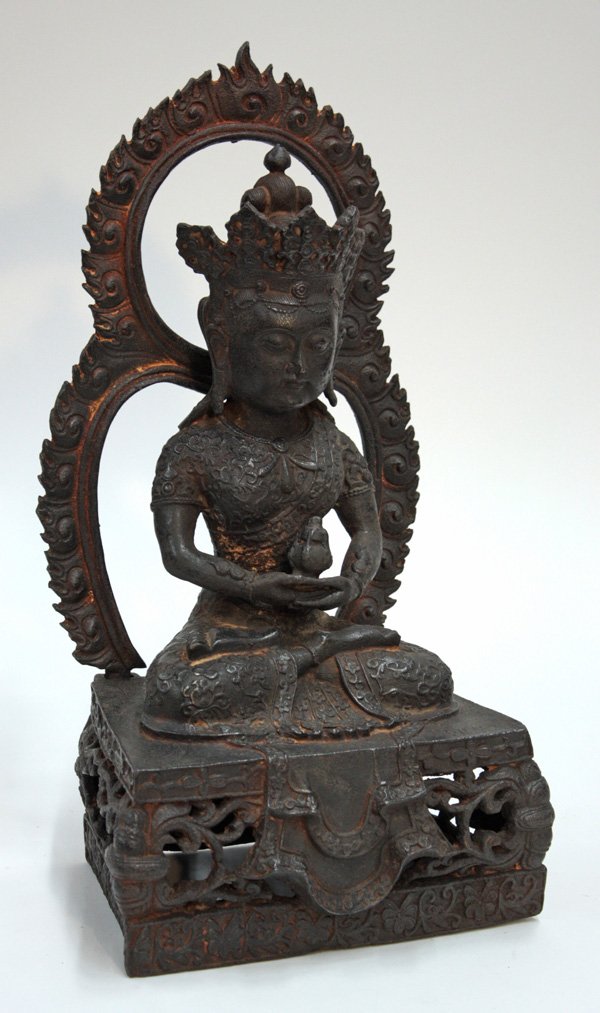 Chinese Cast Iron Buddhist Figure, Qing: Chinese cast iron figure of a Buddhist deity, late Qing dynasty, the bodhisattva wearing brocade patterned robes and seated in a pose of meditation on a high pedestal base with reticulated foliate pan