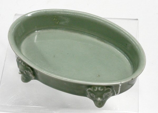 Chinese Celadon Glazed Brush Washer: Chinese celadon glazed porcelain brush washer, late Qing dynasty, of oval shape with low sides flaring at the rim and raised on four ornate supports, the base with an apocryphal Yongcheng reign mark, 