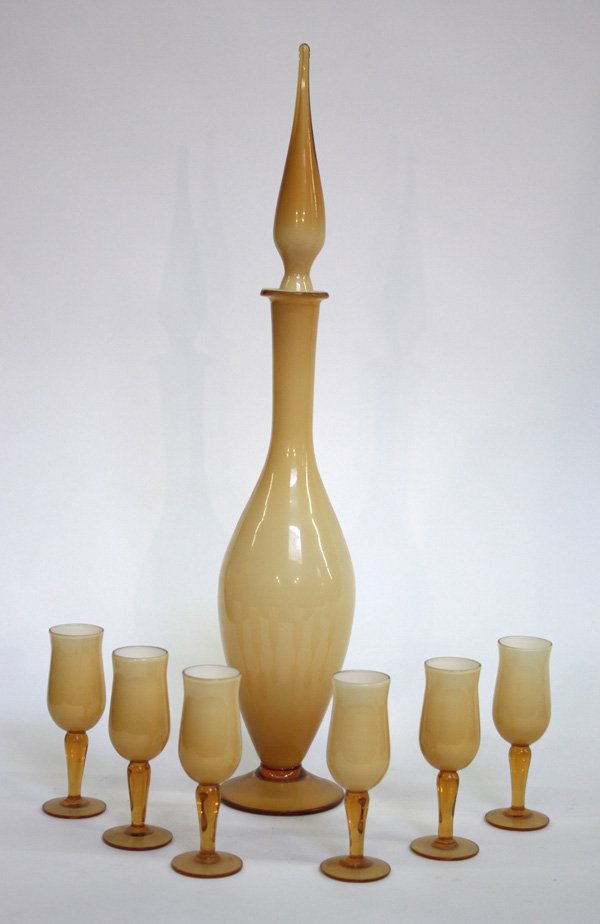 Vintage art glass decanter cordials: Vintage art glass suite comprising a tear drop stoppered decanter and six cordials of cased amber and white glass on amber stems