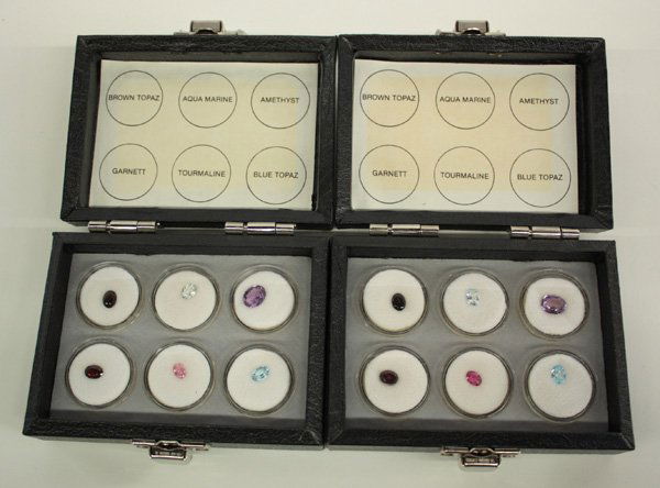 Two presentation boxes with gemstones: Two presentation boxes, each with (6) bubble cased loose gem stones; each case containing (1) each of the following: smokey quartz, pink tourmaline, aquamarine, amethyst, garnet and blue topaz.