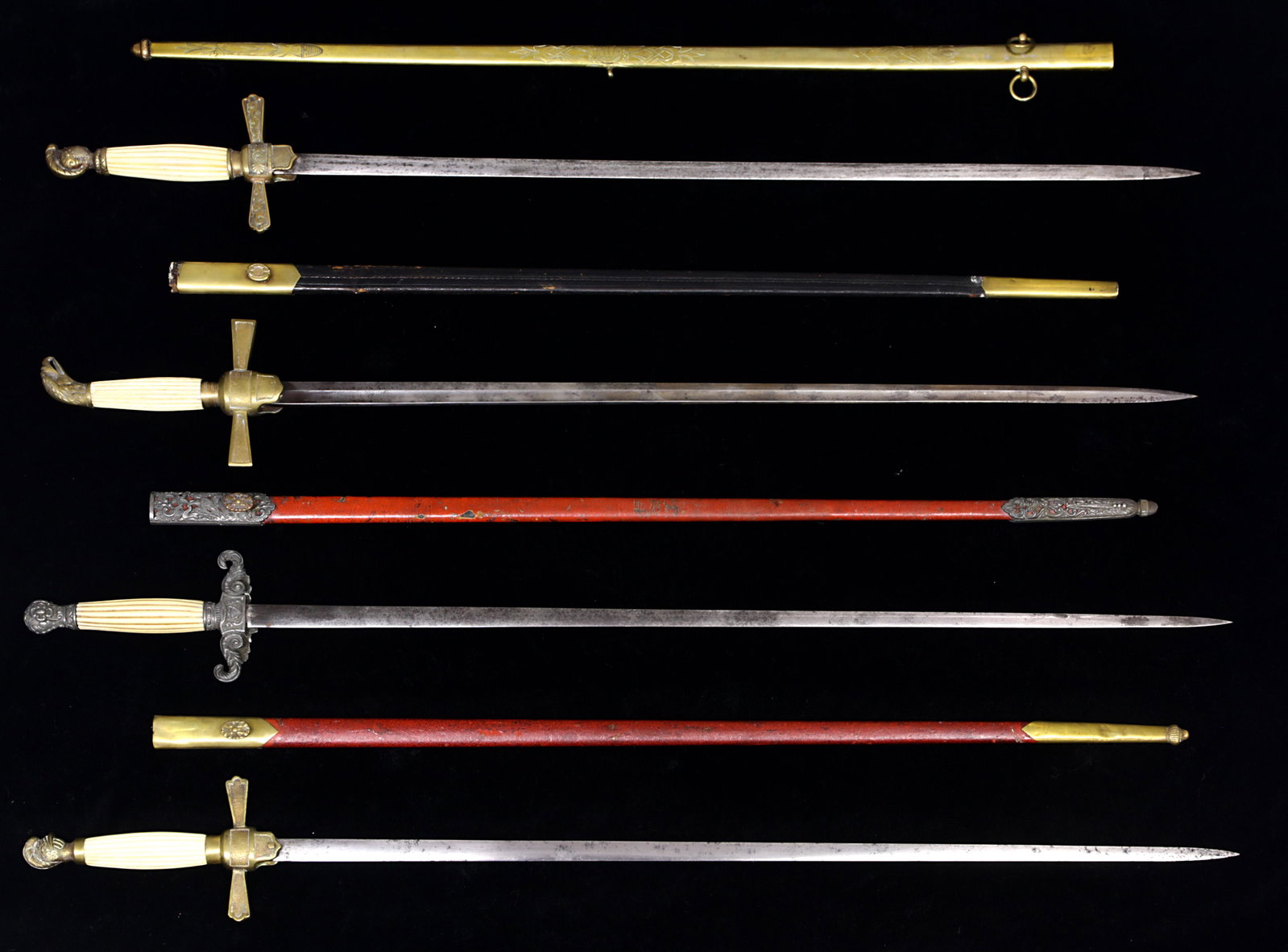 (lot of 4) 19th Century US Militia swords: (lot of 4) 19th Century US Militia swords: the first, an 1850 US Militia sword with a helmet form pommel cap, a fluted bone grip, a shield shaped langer, the red leather scabbard with a gilt brass thr