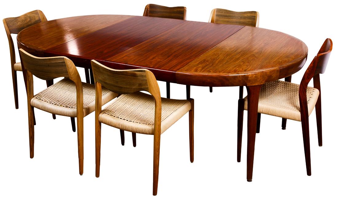 Niels Moller Model 71 rosewood dining chairs: (lot of 7) Niels Moller Model 71 rosewood dining chairs, each having paper cord seats, and rising on tapered legs, 29"h, together with an Ib Kofod-Larsen for Farrup rosewood dining table, having a cir