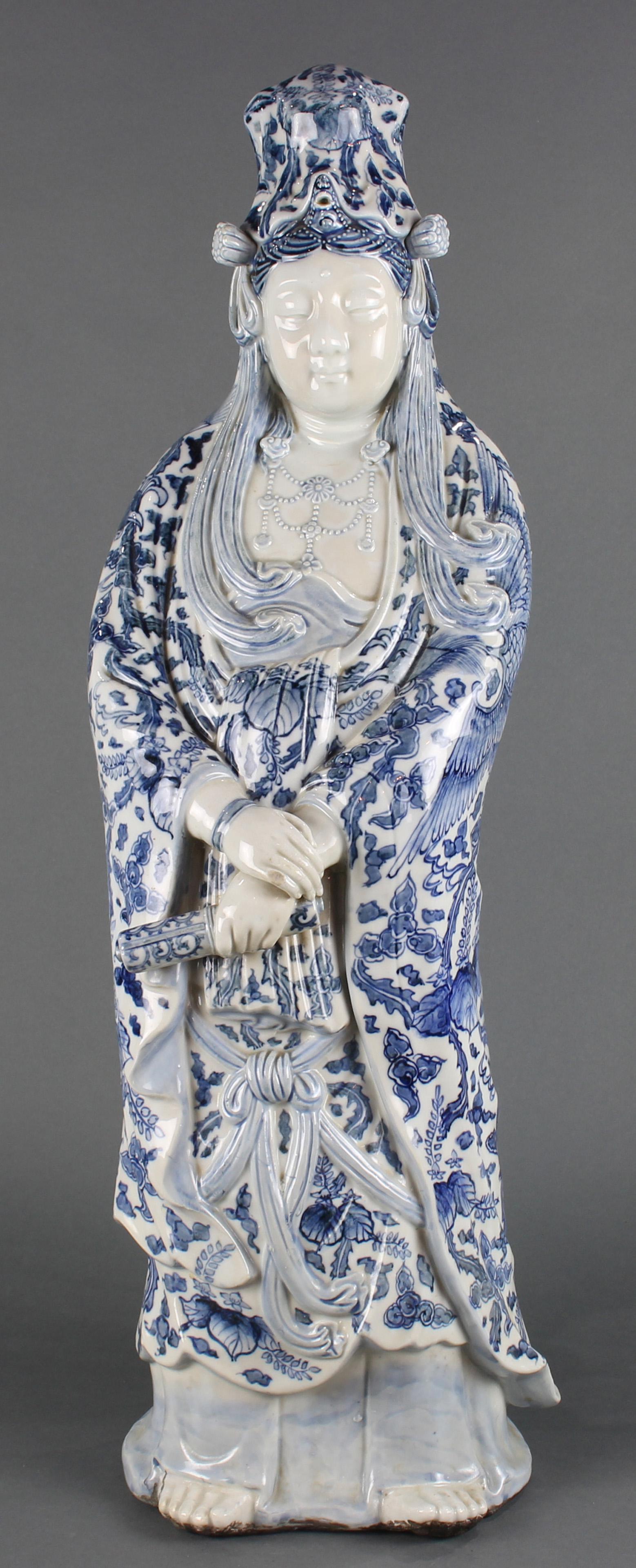 A Japanese Arita blue and white Bodhissatva, Meiji: A Japanese Arita blue and white porcelain figure of standing Bodhissatva, Meiji Period, the deity standing holding a scroll, her headress with lotus blossoms, her diadem necklace with ruyi sceptre and