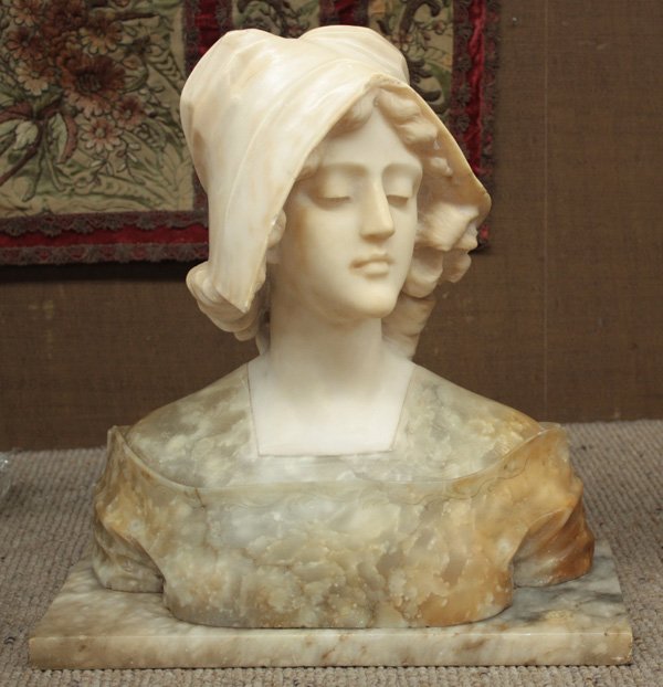 Victorian two-color marble bust: Victorian two-color marble bust modeled after a beauty wearing sun bonnet, the face in white marble, the shoulder of a grey to amber tone, variegated marble with floral embossing, mounted to a rectang