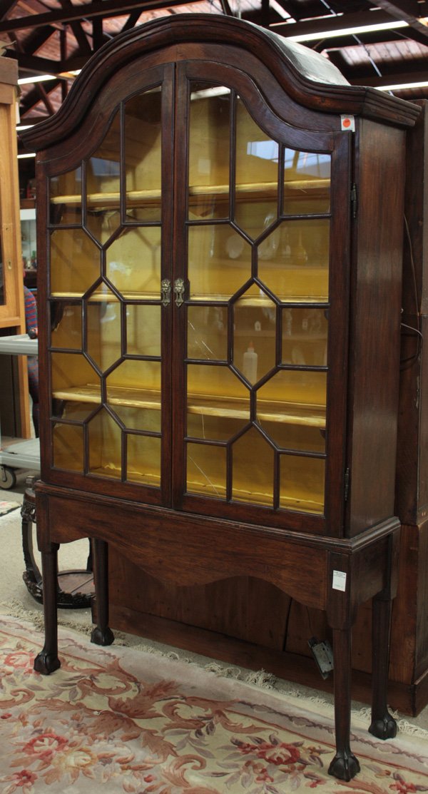 Georgian style display cabinet: Georgian style display cabinet, in two parts comprised of 18th century elements, with mullion paneled doors, lion head brass escutcheons, rising on tapering round legs terminating in ball and claw fee