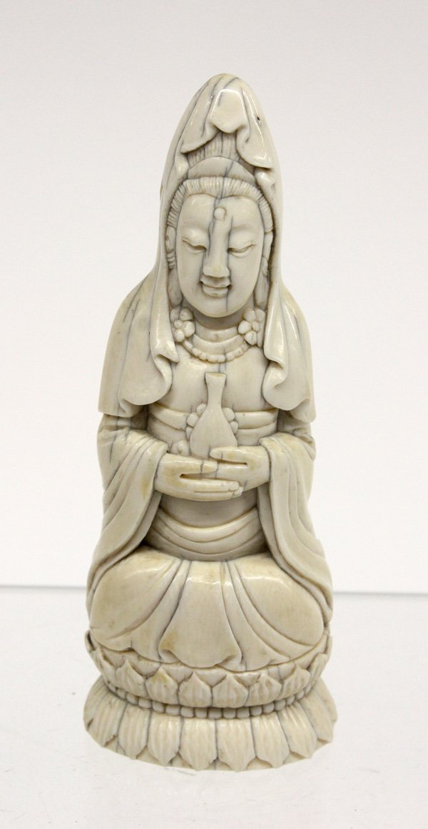 Chinese Small Ivory Guanyin Figure: Chinese ivory figure of Guanyin, early 20th century, the deity seated on a double lotus pedestal and holding an amphora to the front, the smiling face with a serene expression (crazing), 4.75''h