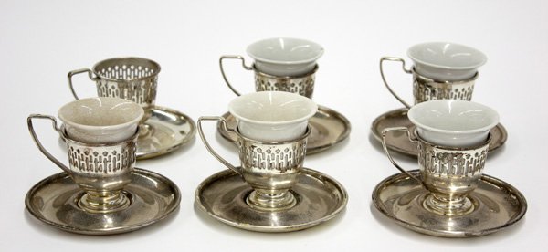 Silver plated demitasse service, porcelain liner: (lot of 17) Silver plated demitasse service for six, comprising porcelain liners and silver plated reticulated cup mounts and saucers, porcelain and saucers marked 'E & JB,' assembled overall 3''h (la