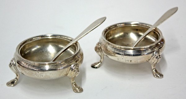 Tiffany & Co. sterling silver master salts: (lot of 4) Pair of Tiffany & Co. sterling silver master salts on tripod bases, with ringed knees, circa 1917, monogrammed 'NLM,' with matching Tiffany sterling salt spoons, 6 troy oz. Provenance: From