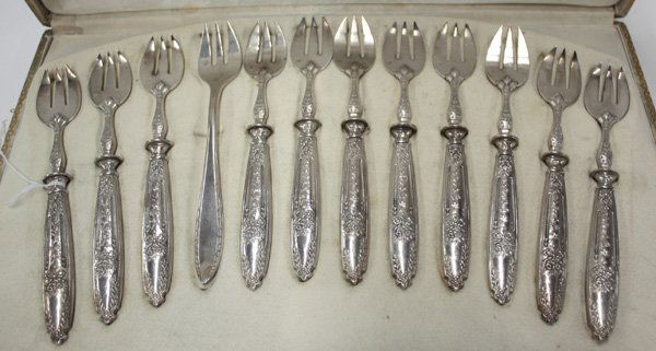 silver plate oyster forks: (lot of 12) Cased set of eleven silver plate oyster forks having floral and bow motif, probably French, with maker's mark 'ARD' and figure in a square, with a Christofle French silver plate oyster for