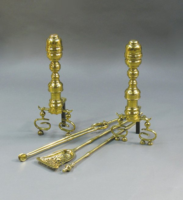 brass Empire andirons implements, Merv Griffin: (lot of 5) Pair of brass Empire andirons with scroll base on ball feet, together with three associated fire implements including a reticulated shovel, 22''h with 5'' dogs. Provenance: The Merv Griffin