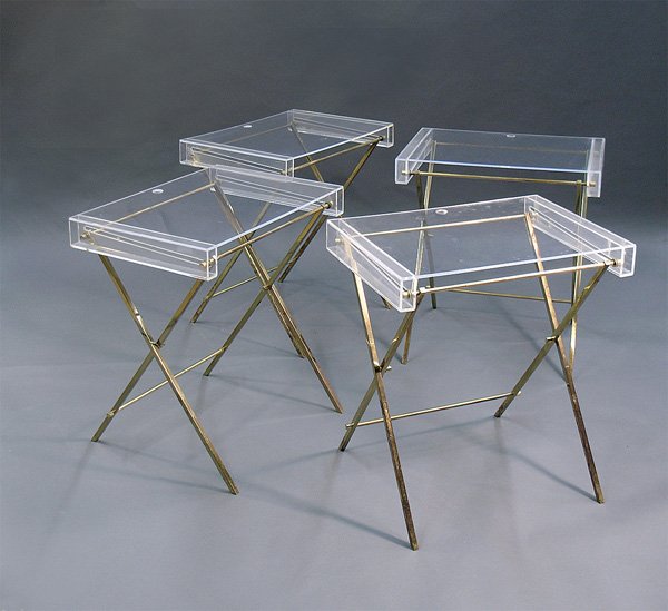 Lucite brass tv trays, Merv Griffin: Set of four Lucite and brass high quality tv trays, 24.5''h x 10.5''w x 16''d. Provenance: Collection of Tony Griffin - selected items left to him by his father