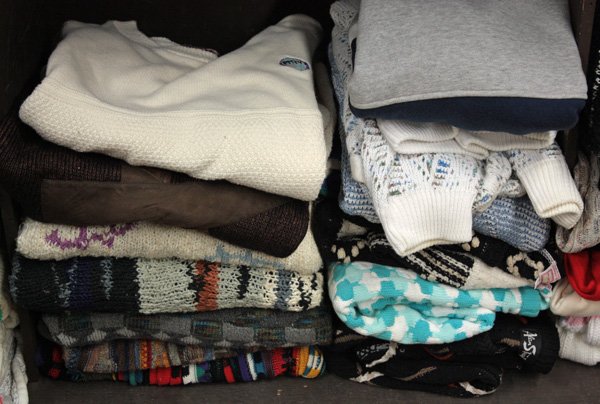 Sweaters, Merv Griffin: One shelf of approximately 12 sweaters, mostly retro patterns by various makers, and including one ivory sweater with 'PMTV' logo. Provenance: The Collection of Tony Griffin - selected items left to h