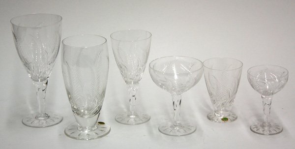 Stuart Crystal stemware: Three shelves of Stuart Crystal stemware having a botanical design comprising 12 red wines, 12 sherrys, 12 champagnes, 10 aperitifs, 10 sherbets, and 7 tumblers