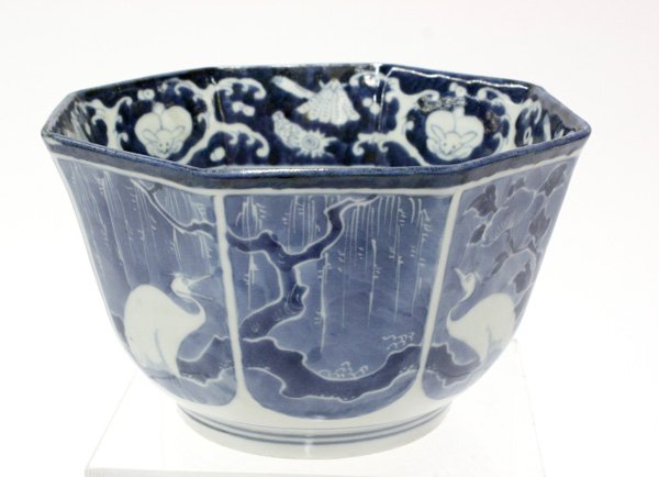 Japanese Arita Blue-and-White Bowl: Japanese Arita ware octangonal bowl, 19th century, the deep interior well with a crane eating a fish below a band with rabbits, waves and seashells, the exterior with heron amid flowering peony and wi