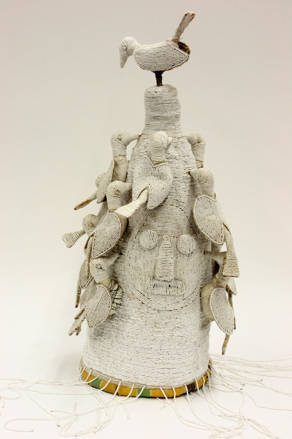 Beaded ceremonial crown Yoruba Nigeria: (lot of 2) Beaded ceremonial crowns, Yoruba tribe, Nigeria, each conically shaped in a subtle white on white decorated throughout and surmounted with birds, long white beaded fringe, 23''h x 9''w x 9'