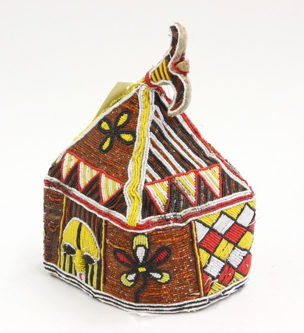 Beaded ceremonial cap Yoruba Nigeria: (lot of 2) Beaded ceremonial cap, Yoruba tribe, Nigeria, having yellow, red, black, and white patterns of varying geometric designs, masks, and floral accents, 10''h x 8''w x 7''d, together with a bea
