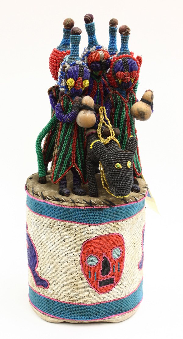 Beaded ceremonial crown Yoruba Nigeria: (lot of 2) Beaded ceremonial crowns, Yoruba tribe, Nigeria, one with off-white drum form base decorated with red mask and blue animals, supporting a figural group with detailed adornments and accoutre