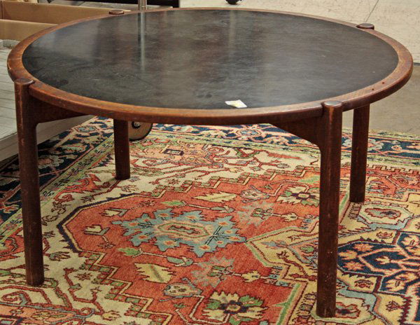 Hans Wegner for Johannes Hansen, teak table: Hans Wegner for Johannes Hansen, Danish Modern teak cocktail table with circular top inset with black laminate, on dowel-leg X-base, branded mark ''Johannes Hansen Copenhagen Denmark'' 19'' x 37'' dia