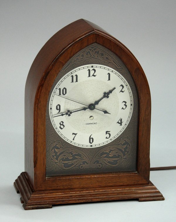 Wrought iron planter: Hammond walnut cased electric beehive clock with engraved dial, 11.5''h
